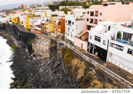 Top view of the city of Punta Brava and a married couple near the city of Puerto de la Cruz on the island of Tenerife, Canary Islands, Atlantic Ocean, Spain Top view of the city of Punta Brava and a married couple near the city of Puerto de la Cruz on the island of Tenerife, Canary Islands, Atlantic Ocean, Spain 87957744