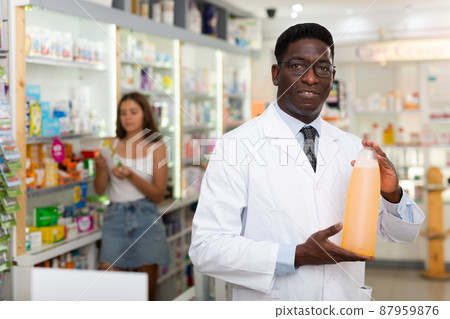 Pharmacist demonstrating haircare product Pharmacist demonstrating haircare product 87959876