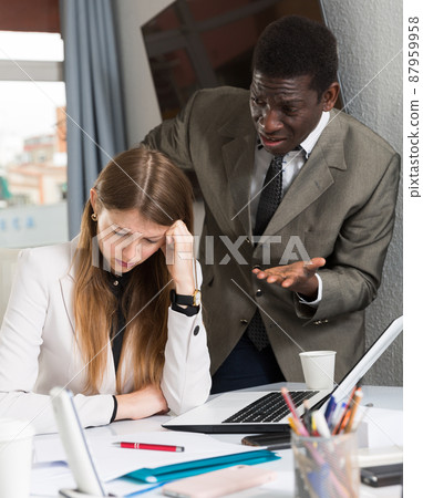 Upset woman with angry boss 87959958
