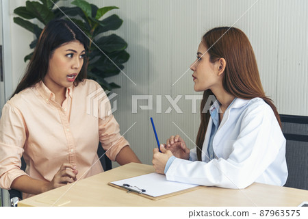 Woman doctor holding hands patient encourage cheer up consultation at hospital medicare treatment clinic. Doctor talking to patient support giving hope listening takecare for mental health therapy Woman doctor holding hands patient encourage cheer up consultation at hospital medicare treatment clinic. Doctor talking to patient support giving hope listening takecare for mental health therapy 87963575