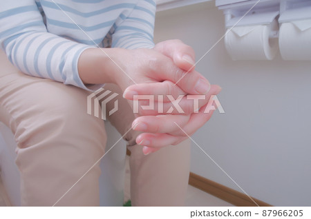 Woman sitting on the toilet seat 87966205