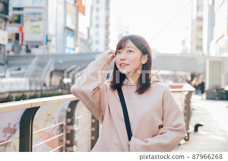 Woman walking in the city of Osaka Woman walking in the city of Osaka 87966268