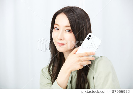Woman holding a smartphone Woman holding a smartphone 87966953