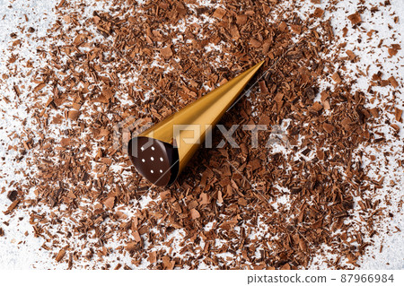 Grated chocolate and candy on gray background Grated chocolate and candy on gray background 87966984