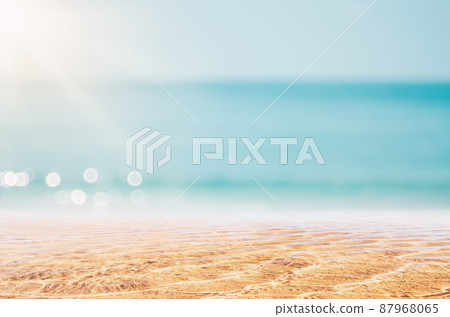 Copy space blur tropical beach with bokeh sun light wave on blue sky and white cloud abstract background. 87968065