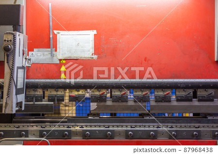 closeup view of industrial sheet bending press brake with tool 87968438