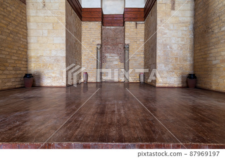 Niche with two marble columns surrounded by recessed frame stone bricks wall and wooden floor Niche with two marble columns surrounded by recessed frame stone bricks wall and wooden floor 87969197