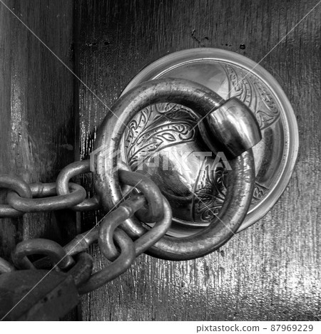 Antique copper ornate door knocker and rusted chain, Eyup Sultan Mosque, Istanbul, Turkey Antique copper ornate door knocker and rusted chain, Eyup Sultan Mosque, Istanbul, Turkey 87969229