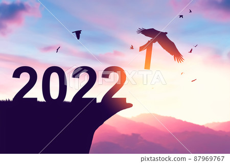 2022 new year concept with eagle bird flying away and holding number 1 on sunset sky background at top of mountain. 2022 new year concept with eagle bird flying away and holding number 1 on sunset sky background at top of mountain. 87969767