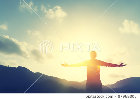Copy space of man hand raising on top of mountain and sunset sky abstract background. Freedom travel adventure and business victory concept. Copy space of man hand raising on top of mountain and sunset sky abstract background. Freedom travel adventure and business victory concept. 87969805