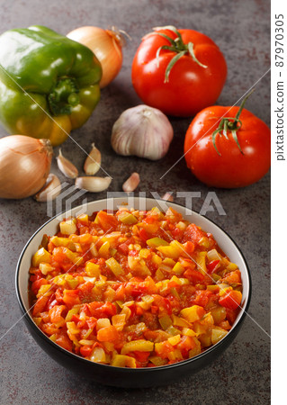 Sofrito Sauce mostly used in Spanish, Italian and Caribbean cooking, to flavour soups and stews closeup in the bowl. Vertical 87970305