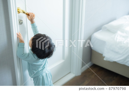 1 year old child trying to open the door 1 year old child trying to open the door 87970798