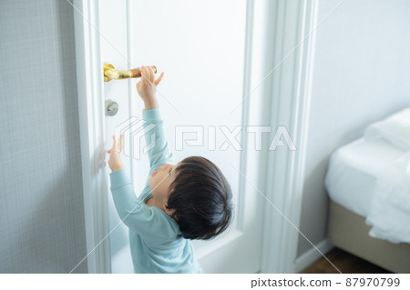 1 year old child trying to open the door 87970799