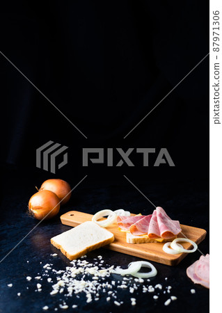 Slices of sausage Mortadella and onion on cutting board Slices of sausage Mortadella and onion on cutting board 87971306