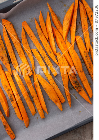 Sweet potato wedges on a baking sheet 87972236