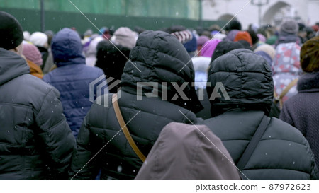 A large group of people are walking along the streets. Refugees fleeing conflict A large group of people are walking along the streets. Refugees fleeing conflict 87972623