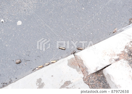 MARIUPOL, UKRAINE - March. 5, 2022: War of Russia against Ukraine. Bullet Case among the cigarettes. MARIUPOL, UKRAINE - March. 5, 2022: War of Russia against Ukraine. Bullet Case among the cigarettes. 87972638
