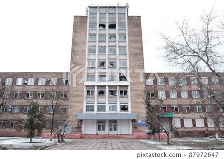 MARIUPOL, UKRAINE - March. 5, 2022: War of Russia against Ukraine. Woman looking for brushwood 87972647