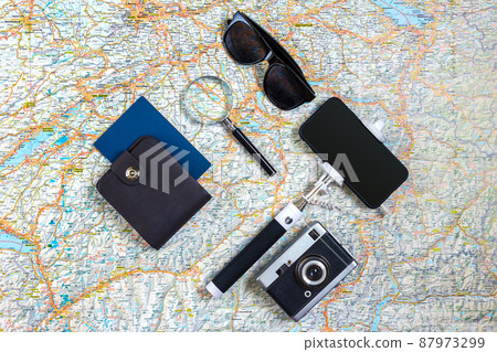 Travel accessories set on white background: smart, passport, map, camera and sunglasses. Top view point. Travel accessories set on white background: smart, passport, map, camera and sunglasses. Top view point. 87973299