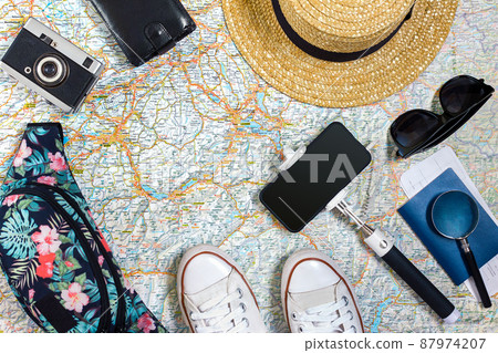 Travel plan, trip vacation accessories for trip, tourism mockup - Outfit of traveler on map background. Flat lay and copyspace. 87974207