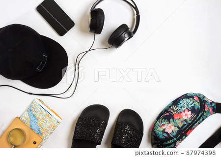 Travel accessories set on white background: smart, headphones, cap, map and bag. Top view point. 87974398