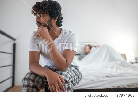 Dejected young male suffering from the break-up Dejected young male suffering from the break-up 87974903