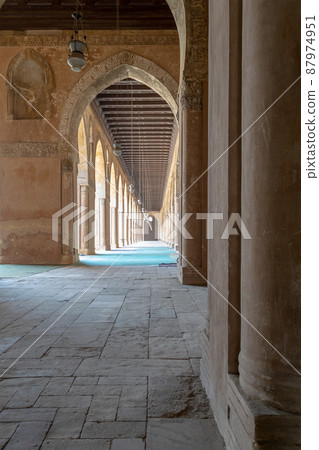 Corridor surrounding the courtyard of the public mosque of Ahmad Ibn Tulun framed by huge decorated arches, old Cairo, Egypt Corridor surrounding the courtyard of the public mosque of Ahmad Ibn Tulun framed by huge decorated arches, old Cairo, Egypt 87974951