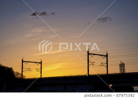 Sunrise and Shinkansen overhead wire pillars 87975392