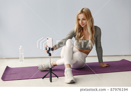 Girl in a sports uniform make yoga at home 87976194