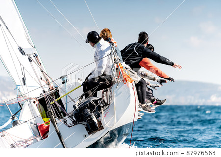 Sailing boat in light wind during regatta competition 87976563