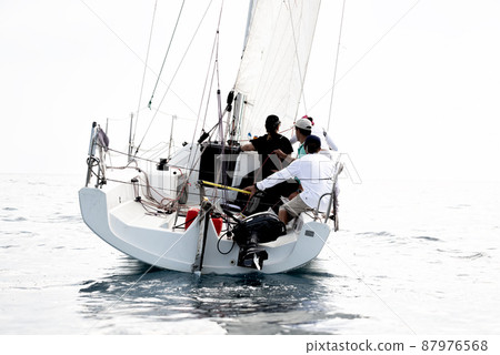 Crew in a boat during sailing yachts regatta 87976568