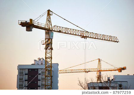 Tower cranes at high residential apartment buildings construction site. Real estate development 87977259
