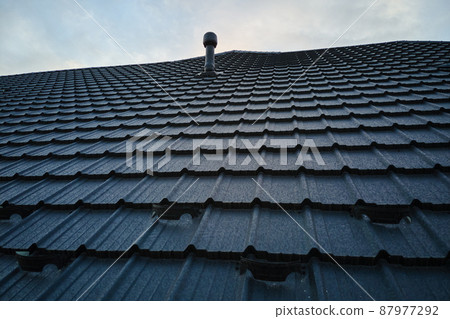 Snow guard for safety in winter on house roof top covered with ceramic shingles. Tiled covering of building Snow guard for safety in winter on house roof top covered with ceramic shingles. Tiled covering of building 87977292