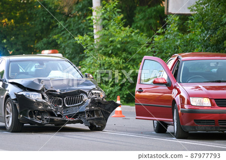 Damaged in heavy car accident vehicles after collision on city street crash site. Road safety and insurance concept. 87977793