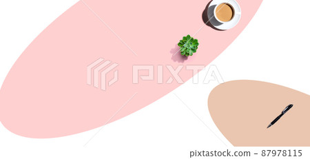 A cup of coffee and and a pen on an open writing desk 87978115