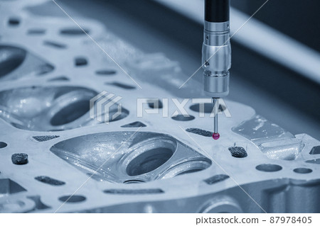 The CMM machine measuring the cylinder head parts . The CMM machine measuring the cylinder head parts . 87978405