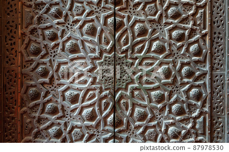 Bronze-plate door ornaments at mosque of Sultan Hassan decorated with floral and geometric patterns, Cairo, Egypt 87978530