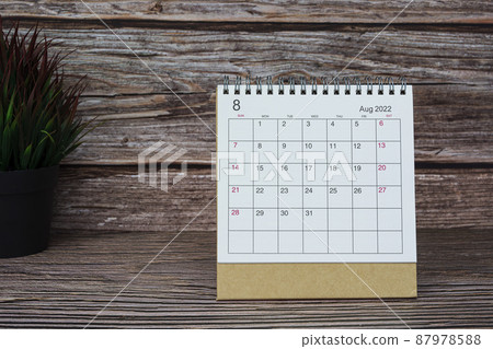 White August 2022 calendar on wooden desk. 2022 new year concept. White August 2022 calendar on wooden desk. 2022 new year concept. 87978588