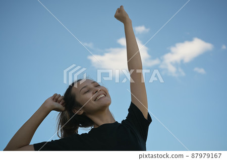 Series photo of young woman in positive emotion with blue sky 87979167