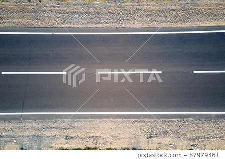 Aerial view of empty intercity road at sunset. Top view from drone of highway in evening Aerial view of empty intercity road at sunset. Top view from drone of highway in evening 87979361