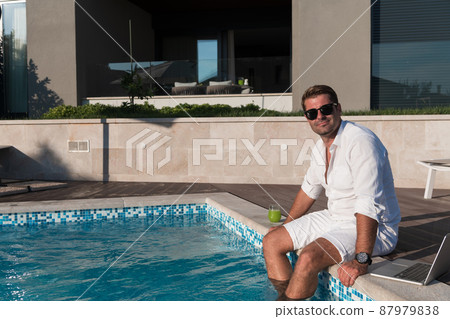 A modern senior man in casual clothes enjoys a vacation in an expensive house. Selective focus  87979838