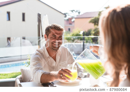 Senior couple eating a healthy breakfast together early in the morning in a luxury house. Selective focus Senior couple eating a healthy breakfast together early in the morning in a luxury house. Selective focus 87980084