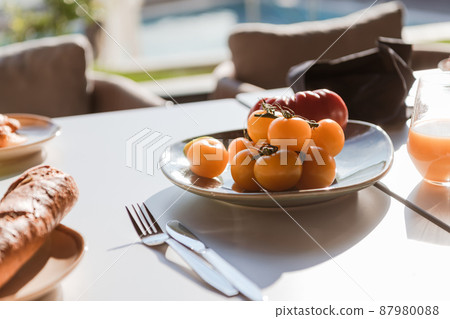 Healthy breakfast served on wooden table in space with window and natural light with yogurt and green smoothie in glasses and glass jar, chopped bread on black plate . Healthy breakfast served on wooden table in space with window and natural light with yogurt and green smoothie in glasses and glass jar, chopped bread on black plate . 87980088