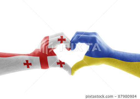 Two hands in the form of heart with Georgian and Ukrainian flag isolated on white background Two hands in the form of heart with Georgian and Ukrainian flag isolated on white background 87980984