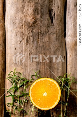Fresh organic sliced orange and rosemary branches Fresh organic sliced orange and rosemary branches 87981025