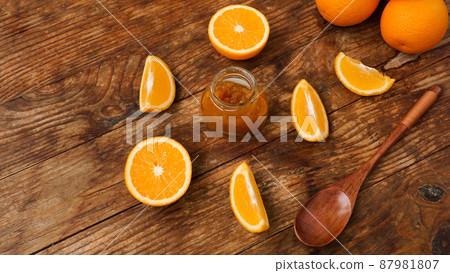 Jar of orange jam on wooden background from top view. 87981807