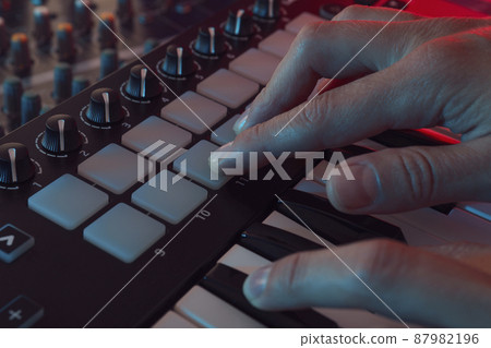 Musician playing on midi keyboard, close up 87982196