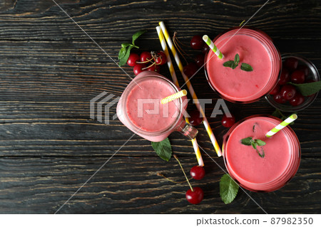 Cherry smoothie and ingredients on rustic wooden table 87982350