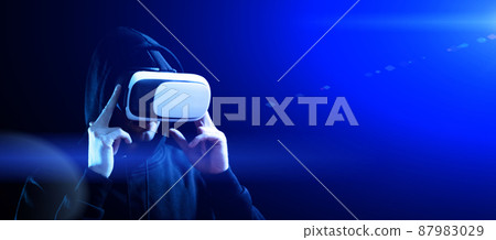 Virtual reality headset vr. Young man in digital glasses for virtual reality technology on dark background. Future tech experience concept. 87983029
