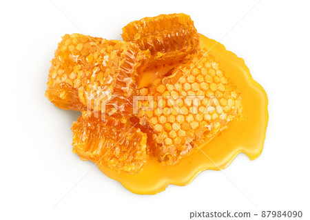Honeycombs and honey puddle isolated on white background with clipping path and full depth of field. Top view. Flat lay 87984090
